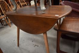 A mid century dining table Ercol model 384 with elm wood top mid stain