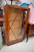 An art deco mahogany display cabinet.