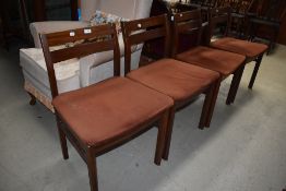 A set of four mid century teak backed chairs, having brown velvet upholstery, possibly G plan