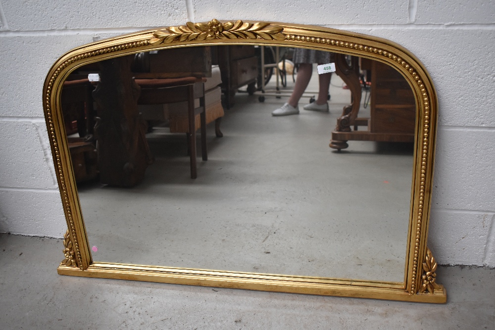 A classically styled gilt framed mantel mirror.