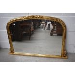 A classically styled gilt framed mantel mirror.