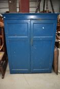 An early 20th century utility cupboard in pitch pine painted