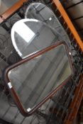 Three vintage bevelled glass wall mirrors in various frames.