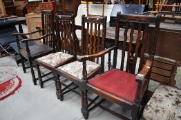 A set of four (two plus two) late Victorian dining chairs having oak frames and snake backs