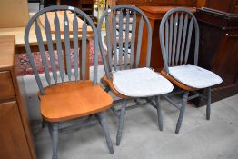 Three modern hoop back dining chairs with beech wood seats