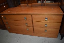 A mid century teak bedroom chest of three by three drawers