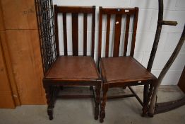 A pair of 20th century oak framed dining chairs having barley twist legs