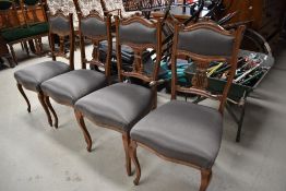 Four Edwardian chairs having intricately carved backs and serpentine fronted seat base, with