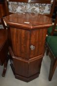 An early Victorian pedestal style comode having octagonal flame mahogany case