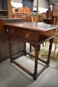 A good quality 20th century reproduction oak side table with drawer