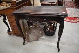 A Victorian style fold over card table having carved applique decoration