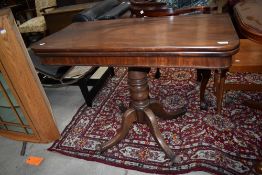 A Victorian mahogany fold over tea table on pedestal base