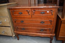 A reproduction chest of two over two drawers