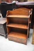 A pair of 20th century low book shelves with under drawer in mahogany, reprodux