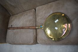 A traditional brass warming pan