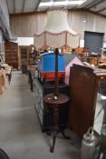 An early 20th Century mahogany standard lamp table having turned column and triple splay legs