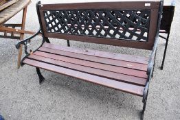 A 20th century garden bench having cast ends and back support