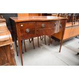 An early 20th Century Regency revival mahogany serpentine fronted sideboard on square tapered legs