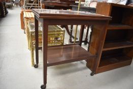 A vintage mahogany fold over tea trolley