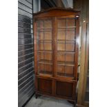 An early 20th century oak book case having leaded light doors with under cupboard