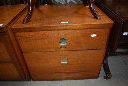 A mid century teak bed side chest of two drawers