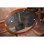 An Edwardian mahogany oval wall mirror