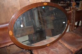 An Edwardian mahogany oval wall mirror