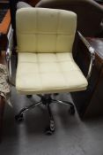 A cream leather office chair.
