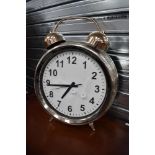 A 20th century over sized alarm clock with chrome finish