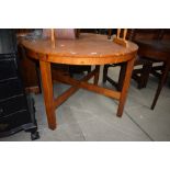 A vintage red stain oak circular dining table