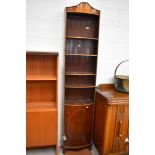 A late 19th/early 20th Century narrow book case with under cupboard mahogany with banded detail