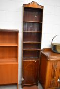 A late 19th/early 20th Century narrow book case with under cupboard mahogany with banded detail