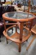 Two mid century circular teak and glass topped coffee tables