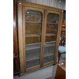 A late 19th/early 20th century vernacular utility cupboard having scumble finish and rolled glass