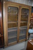 A late 19th/early 20th century vernacular utility cupboard having scumble finish and rolled glass