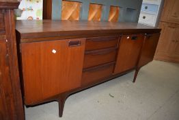 A mid century teak side board or Long John having three drawers and three section cupboard