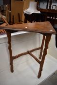 An Arts and Crafts inspired corner table in golden oak