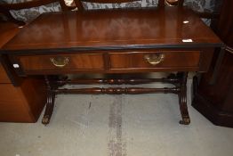 A reproduction coffee table having lions paw feet and double drawer set