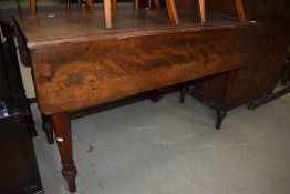 A Victorian drop leaf farm house style table having mahogany frame on turned legs
