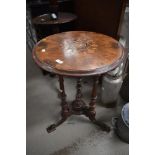 A Victorian side or wine table having turned and carved tripod base with inlay decoration