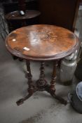 A Victorian side or wine table having turned and carved tripod base with inlay decoration