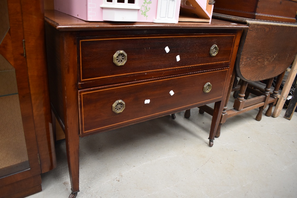 An early 20th century reproduction chest of two drawers in mahogany with inlayed banding and