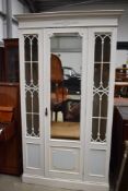 20th century shabby chic painted pine wardrobe having astral glazed doors with centre mirror