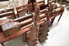 Two antique oak pillars having carved finials, possibly from a chapel or church, believed to be