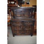 A 20th century dark oak sideboard having under and over cupboard with two drawers