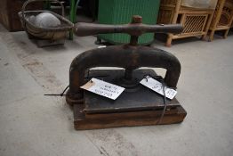 An antique cast iron book press.