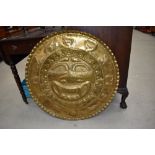 A South American possibly Inca style brass wall plaque with sun god and zodiac signs to border