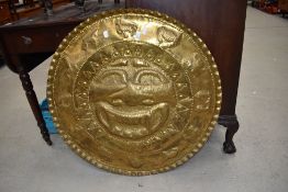 A South American possibly Inca style brass wall plaque with sun god and zodiac signs to border