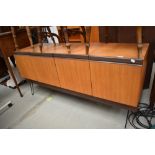 A 1960s E Gomme G Plan sideboard having four doors to two compartments and later hair pin legs.
