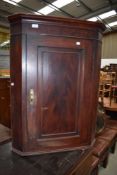 A Victorian corner cupboard with mahogany case